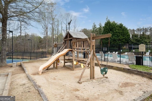 communal playground featuring fence