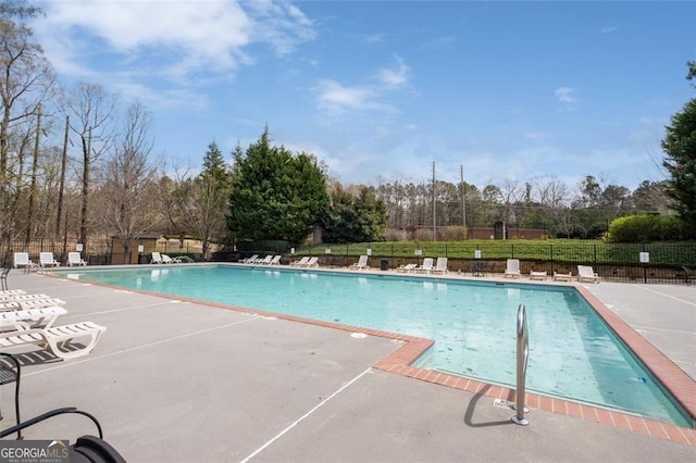 community pool featuring a patio area and fence