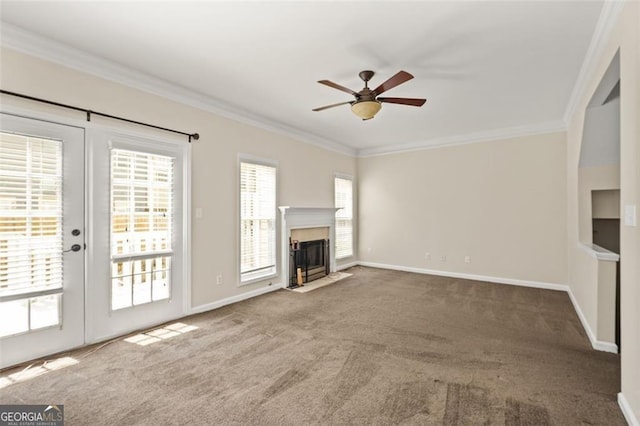 unfurnished living room featuring crown molding, carpet flooring, and ceiling fan