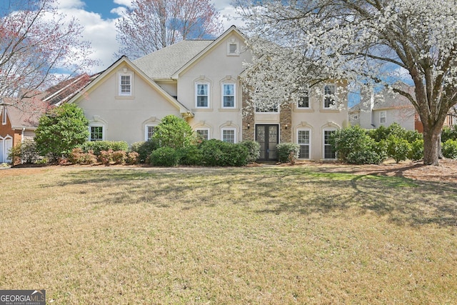 view of front of home with a front lawn and stucco siding