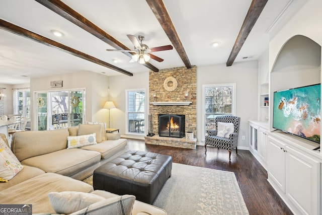 living area with a fireplace, dark wood-style floors, a healthy amount of sunlight, and ceiling fan