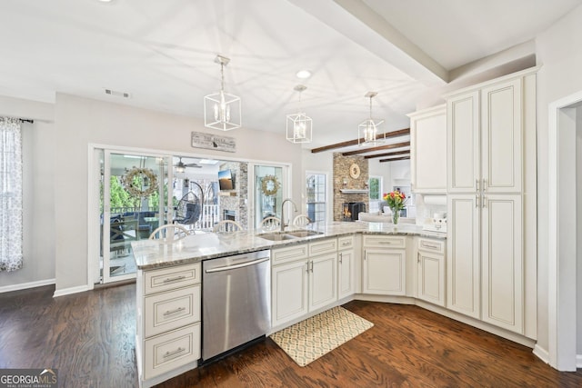 kitchen with dark wood finished floors, dishwasher, light stone counters, a peninsula, and a sink