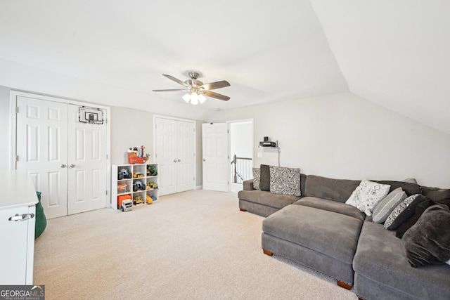 living area with carpet, a ceiling fan, and vaulted ceiling