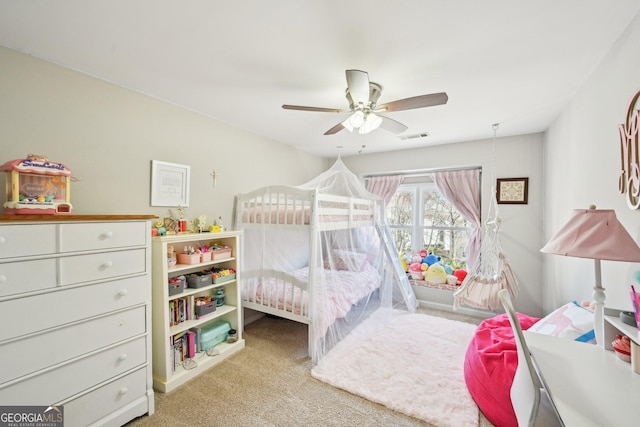 carpeted bedroom with visible vents and ceiling fan