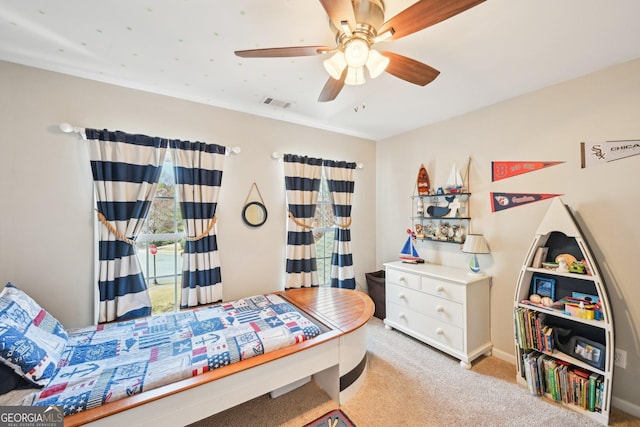 carpeted bedroom featuring visible vents and a ceiling fan