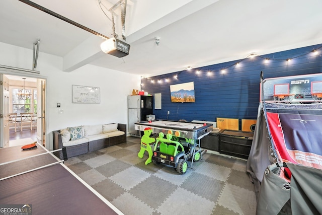 garage featuring a garage door opener and freestanding refrigerator