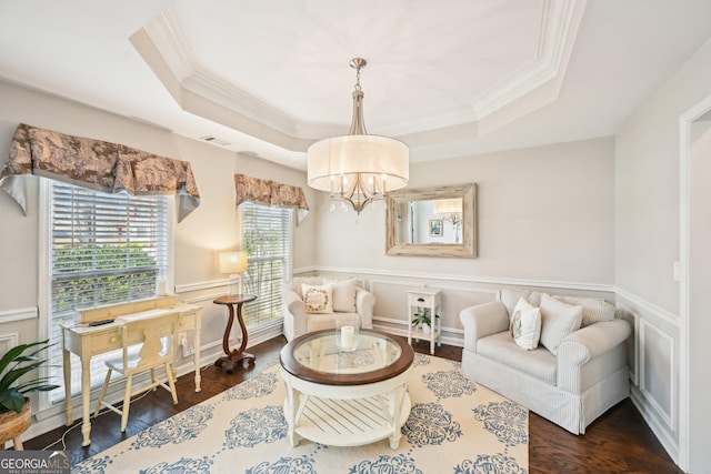 living area with a raised ceiling, visible vents, dark wood-style flooring, and a chandelier