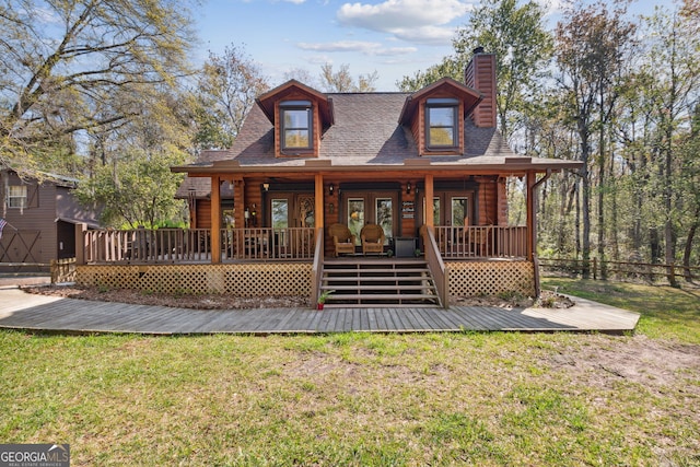 rustic home featuring french doors, a deck, and a front lawn