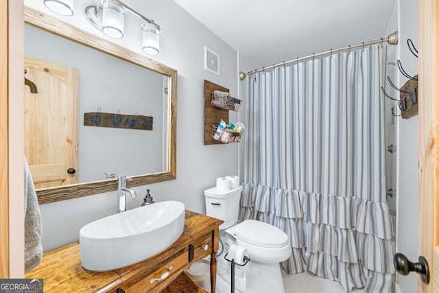 full bath featuring visible vents, vanity, toilet, and a shower with shower curtain