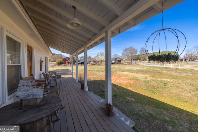 deck with a yard and fence