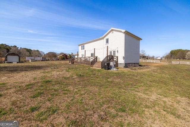 view of property exterior featuring a deck, fence, a lawn, and crawl space