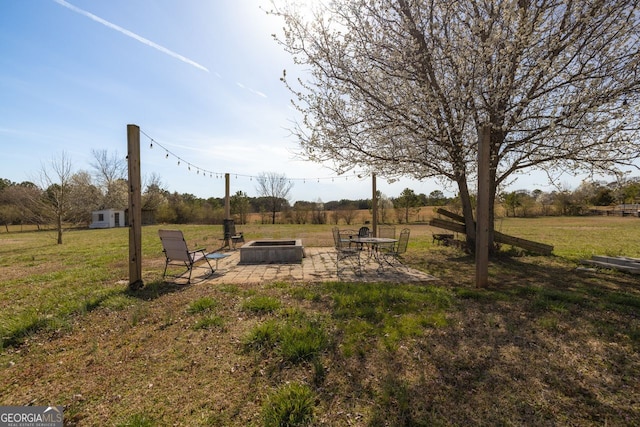 view of yard featuring a patio area and an outdoor fire pit