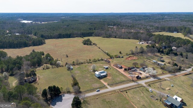 drone / aerial view featuring a forest view and a rural view