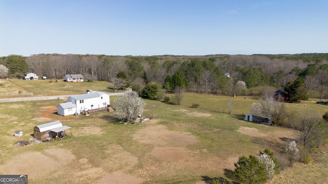 drone / aerial view featuring a rural view and a forest view