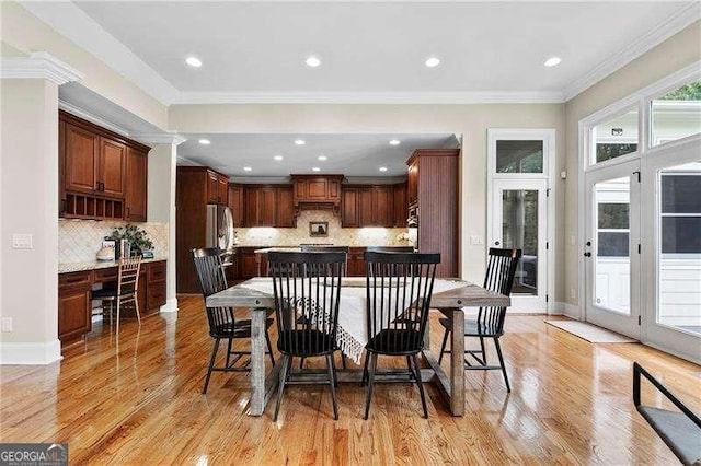 dining space with crown molding, recessed lighting, baseboards, and light wood-type flooring