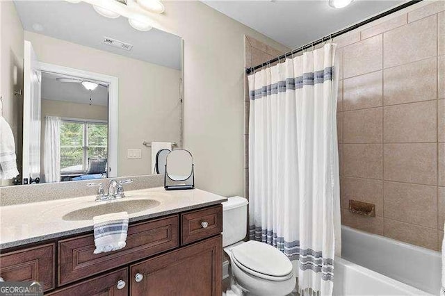 bathroom featuring vanity, toilet, shower / bath combo, and visible vents