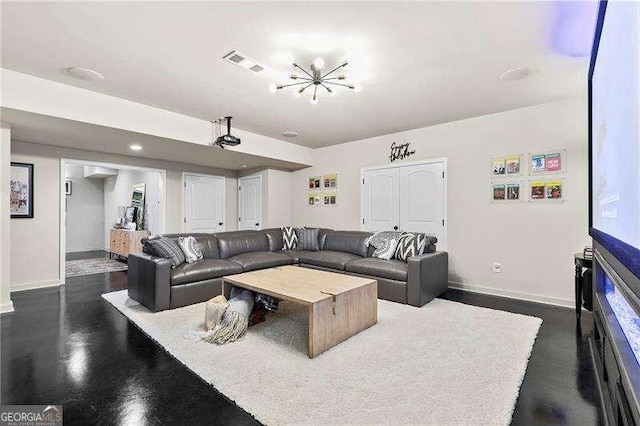 living room with a notable chandelier, baseboards, and visible vents