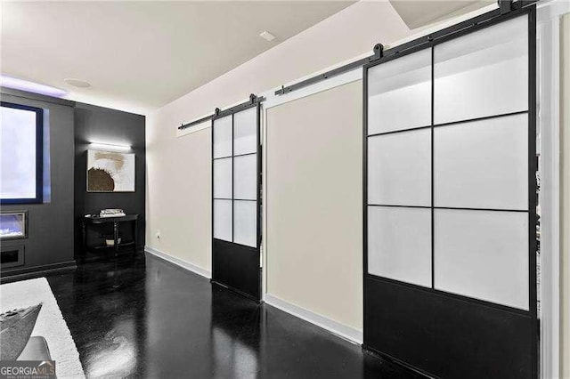 bathroom with baseboards and finished concrete flooring