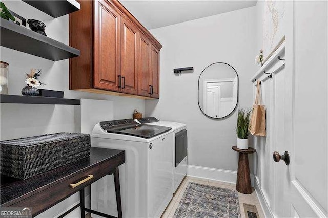 laundry room with baseboards, cabinet space, visible vents, and washer and clothes dryer