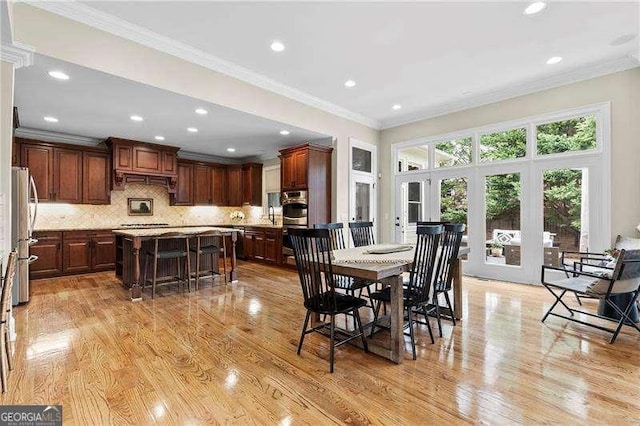 dining room featuring recessed lighting, french doors, light wood-style floors, and crown molding