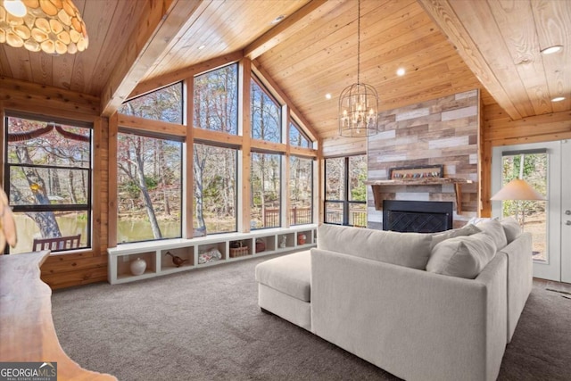 carpeted living room featuring beam ceiling, wooden ceiling, a notable chandelier, and high vaulted ceiling