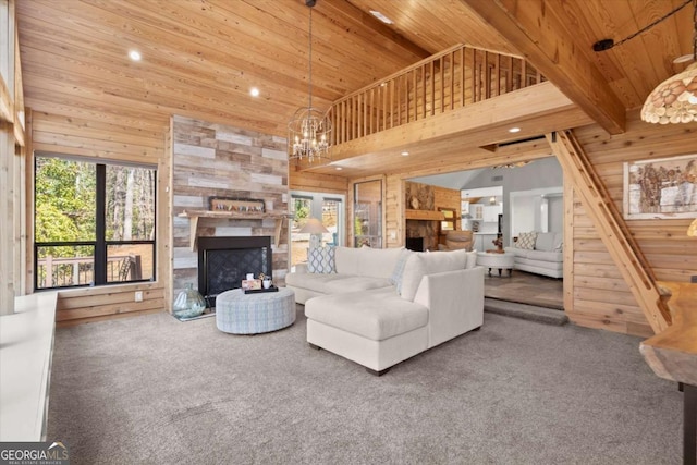 unfurnished living room with carpet flooring, wood ceiling, wood walls, and a fireplace