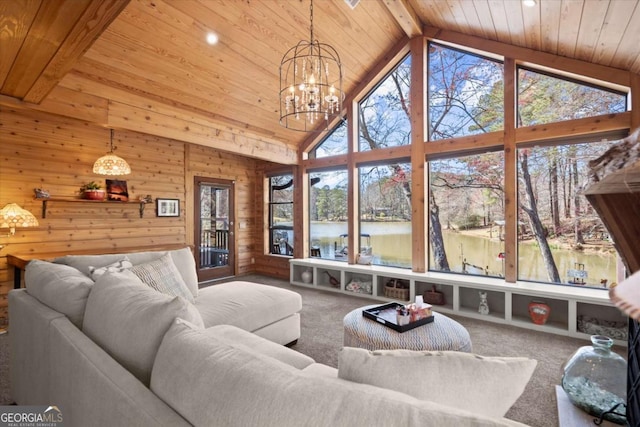 living room featuring wooden walls, carpet, an inviting chandelier, beam ceiling, and wood ceiling