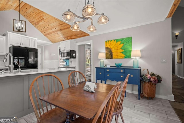 dining space featuring lofted ceiling and wooden ceiling