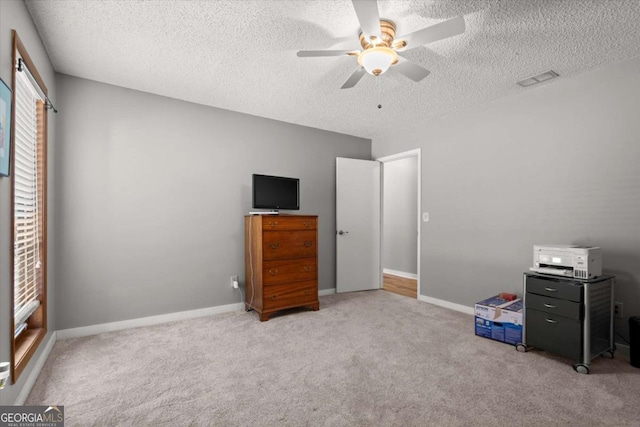 unfurnished bedroom with baseboards, carpet floors, and a textured ceiling