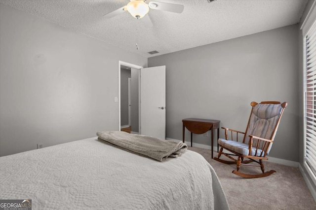 bedroom with baseboards, carpet, visible vents, and a textured ceiling