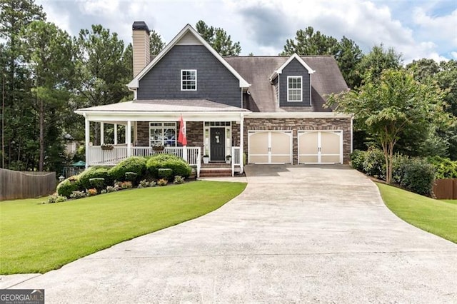 view of front of house with an attached garage, a front lawn, a porch, a chimney, and driveway