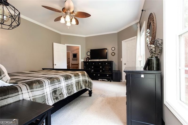 bedroom with light colored carpet, ornamental molding, and a ceiling fan