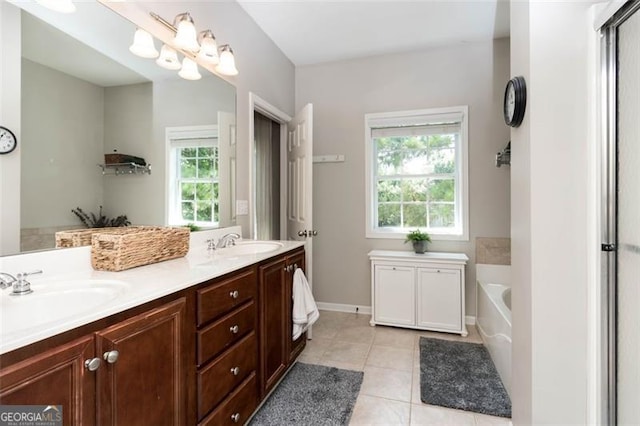 full bath featuring tile patterned flooring, double vanity, a garden tub, and a sink