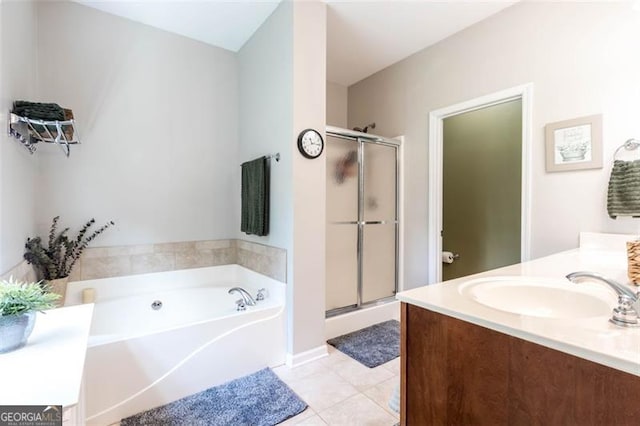 full bath featuring vanity, a garden tub, a stall shower, and tile patterned floors