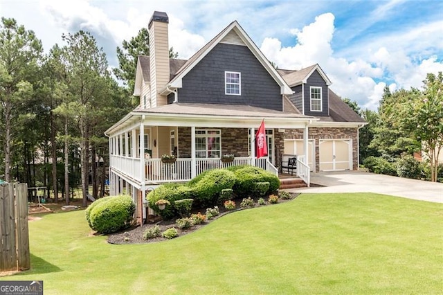 view of front of home featuring a porch, concrete driveway, a front yard, a chimney, and stone siding