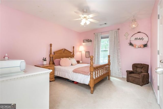 bedroom featuring visible vents, baseboards, light colored carpet, and a ceiling fan