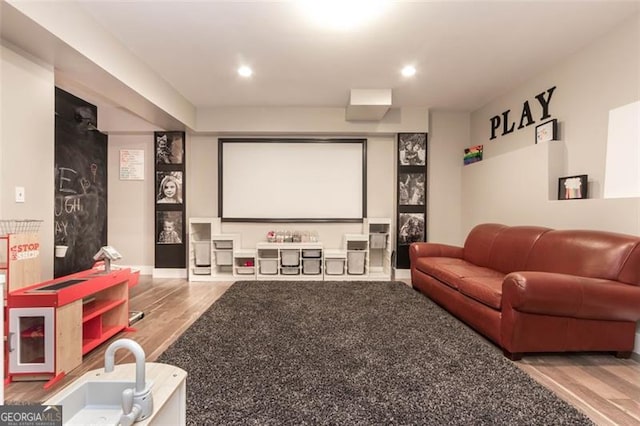 home theater room featuring recessed lighting, baseboards, and wood finished floors