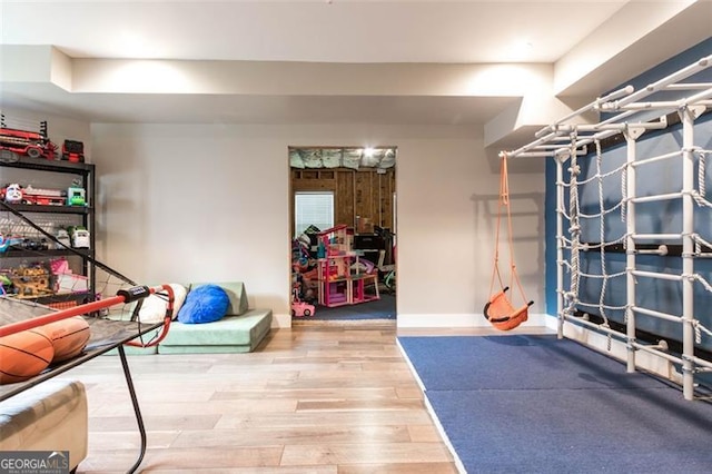 interior space with baseboards and wood finished floors