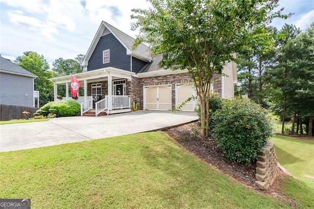 view of front facade featuring driveway, a porch, a front lawn, a garage, and stone siding