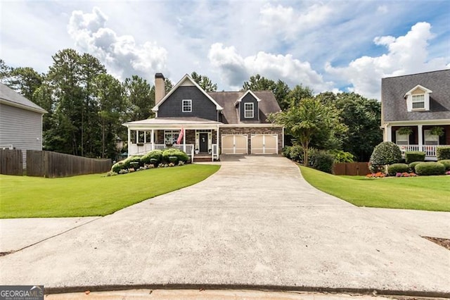 view of front of house featuring covered porch, concrete driveway, a front yard, and fence