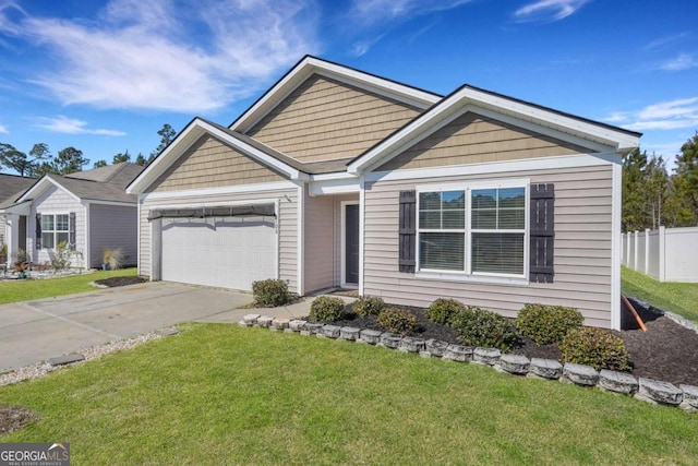 view of front of property featuring driveway, a front lawn, a garage, and fence