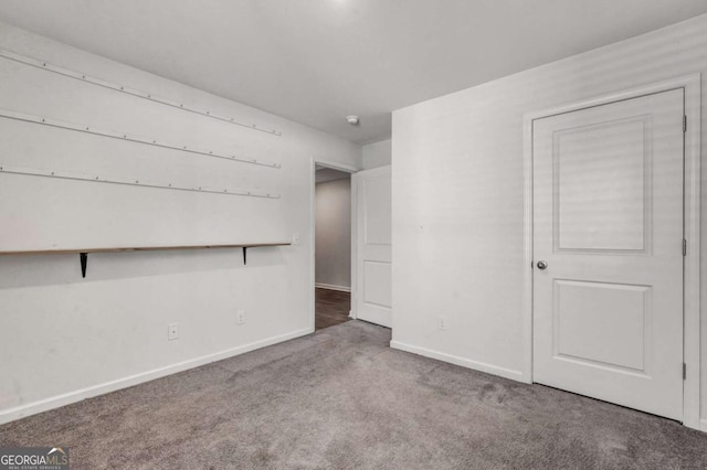 empty room featuring baseboards and carpet floors