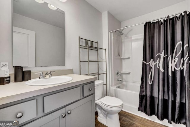 bathroom with vanity, shower / bathtub combination with curtain, toilet, and wood finished floors