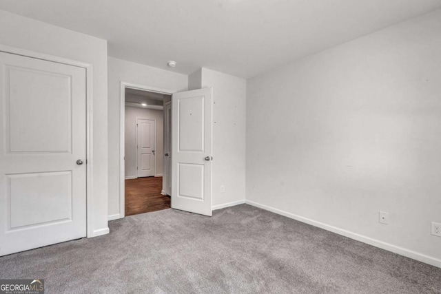 unfurnished bedroom with baseboards and carpet floors