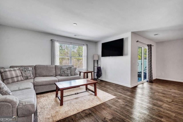 living room with dark wood finished floors and baseboards