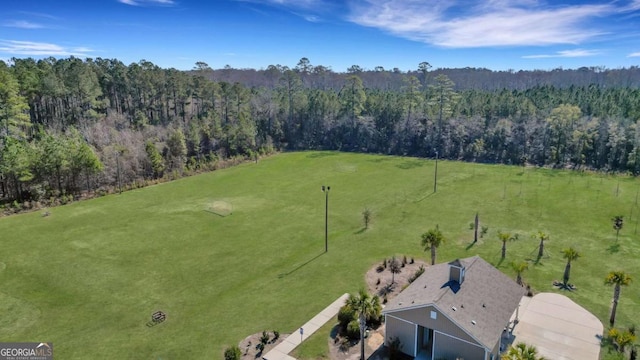 drone / aerial view featuring a view of trees