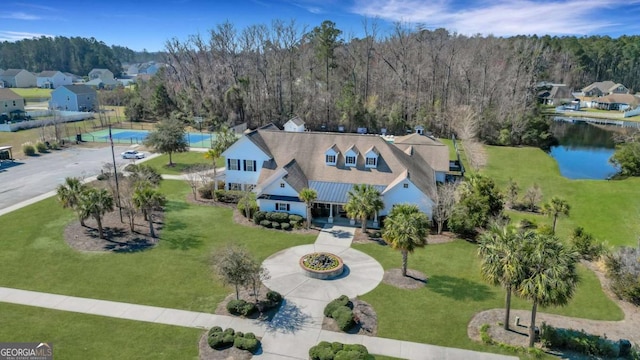 bird's eye view with a wooded view and a water view