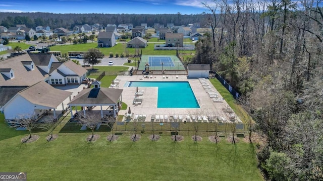 view of pool with a yard and a residential view