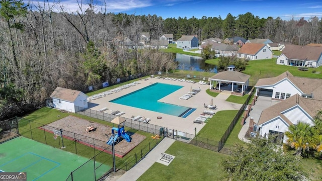 drone / aerial view featuring a view of trees and a residential view