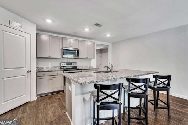 kitchen with visible vents, appliances with stainless steel finishes, gray cabinetry, and a sink